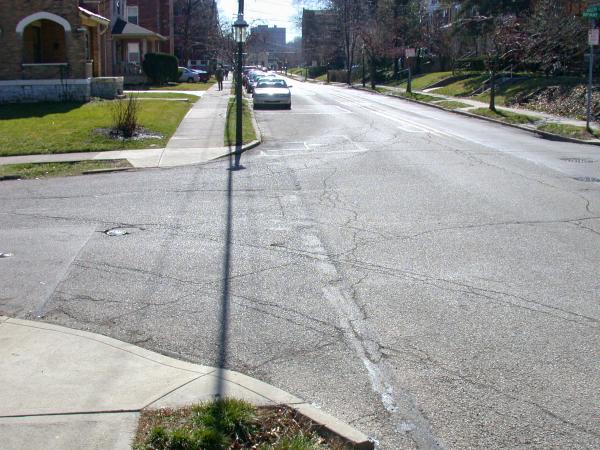 Cracks in the street reveal buried tracks at Middleton Avenue at Bryant Avenue in Clifton
