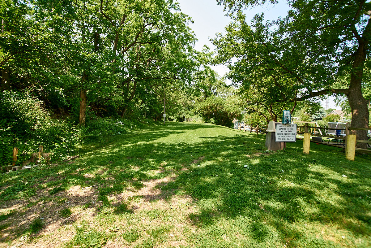 An open area with subtle grading marks the path of the canal and subway in St. Bernard.