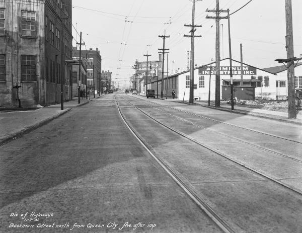 Historic photo of the Cincinnati & Westwood and CH&D Railroads crossing streetcar tracks on Beekman Street in South Fairmount after repaving