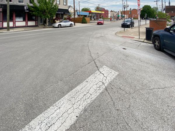 Cracks in the street reveal buried tracks at Greenup Street and Park Place in downtown Covington