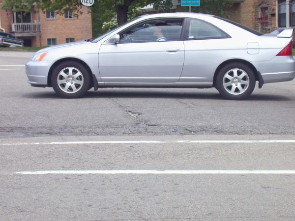 Tracks appearing through deteriorated pavement on Memorial Parkway in Bellevue Kentucky