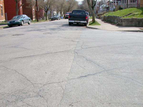Cracks in the street reveal buried tracks at the corner of Edgewood and McMakin in Winton Place